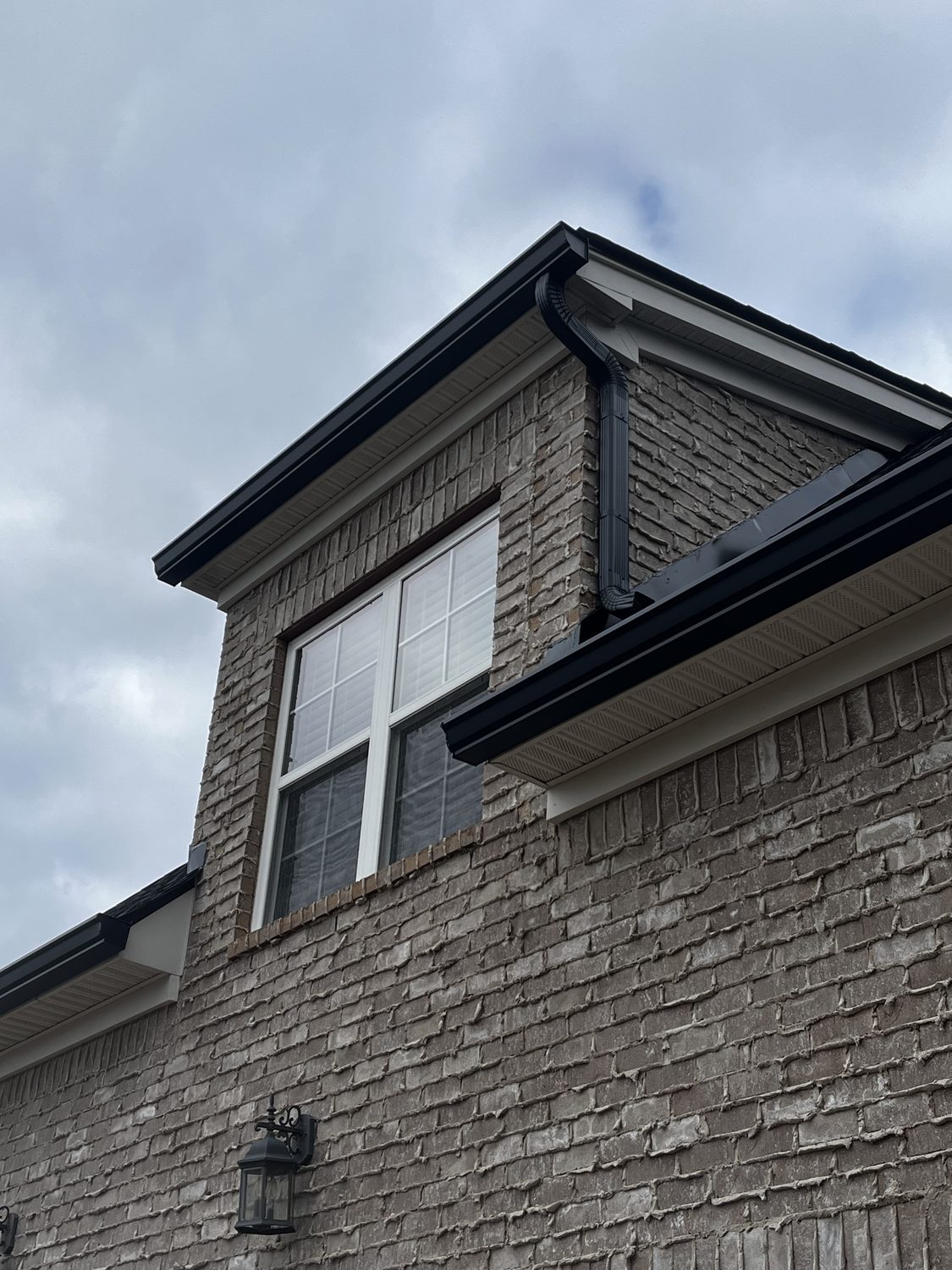 Gutter run above a gable-end window by Gutter And Covers, Cookeville