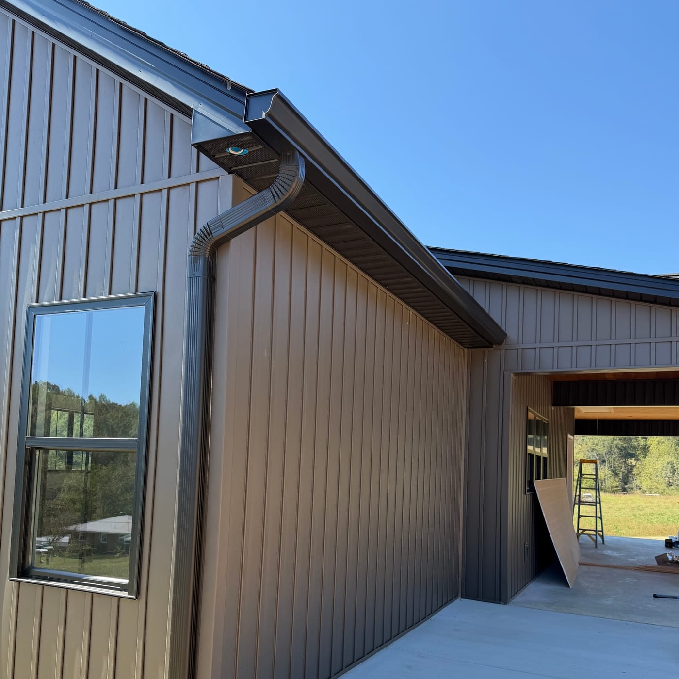 Gutter and downspout on a board-and-batten new build by Gutter And Covers, Cookeville