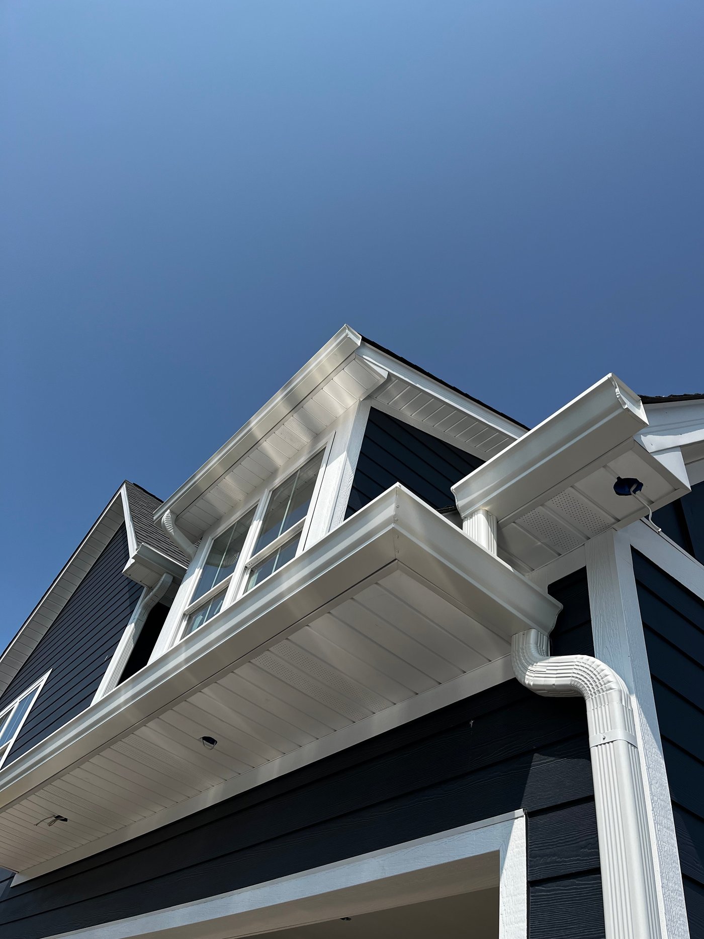 A 4 inch downspout routed down a porch column by Gutter And Covers, Cookeville